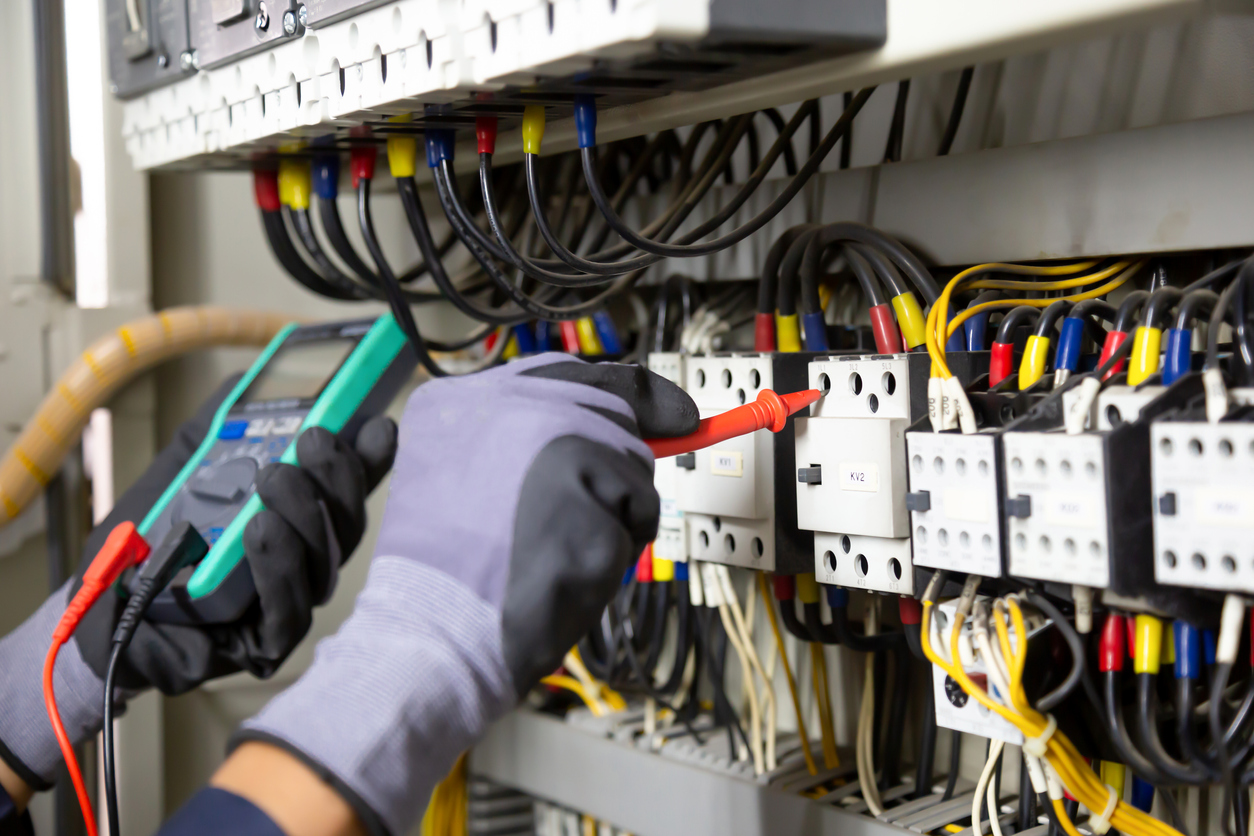 A hand installing an electrical circuit breaker.